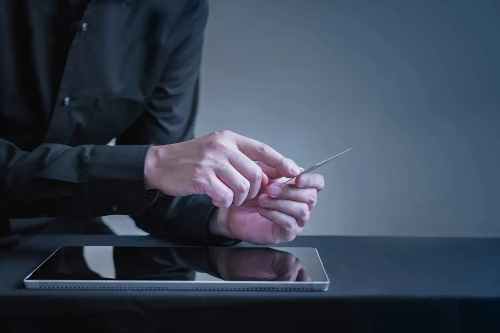 Team reviewing documents around a laptop
